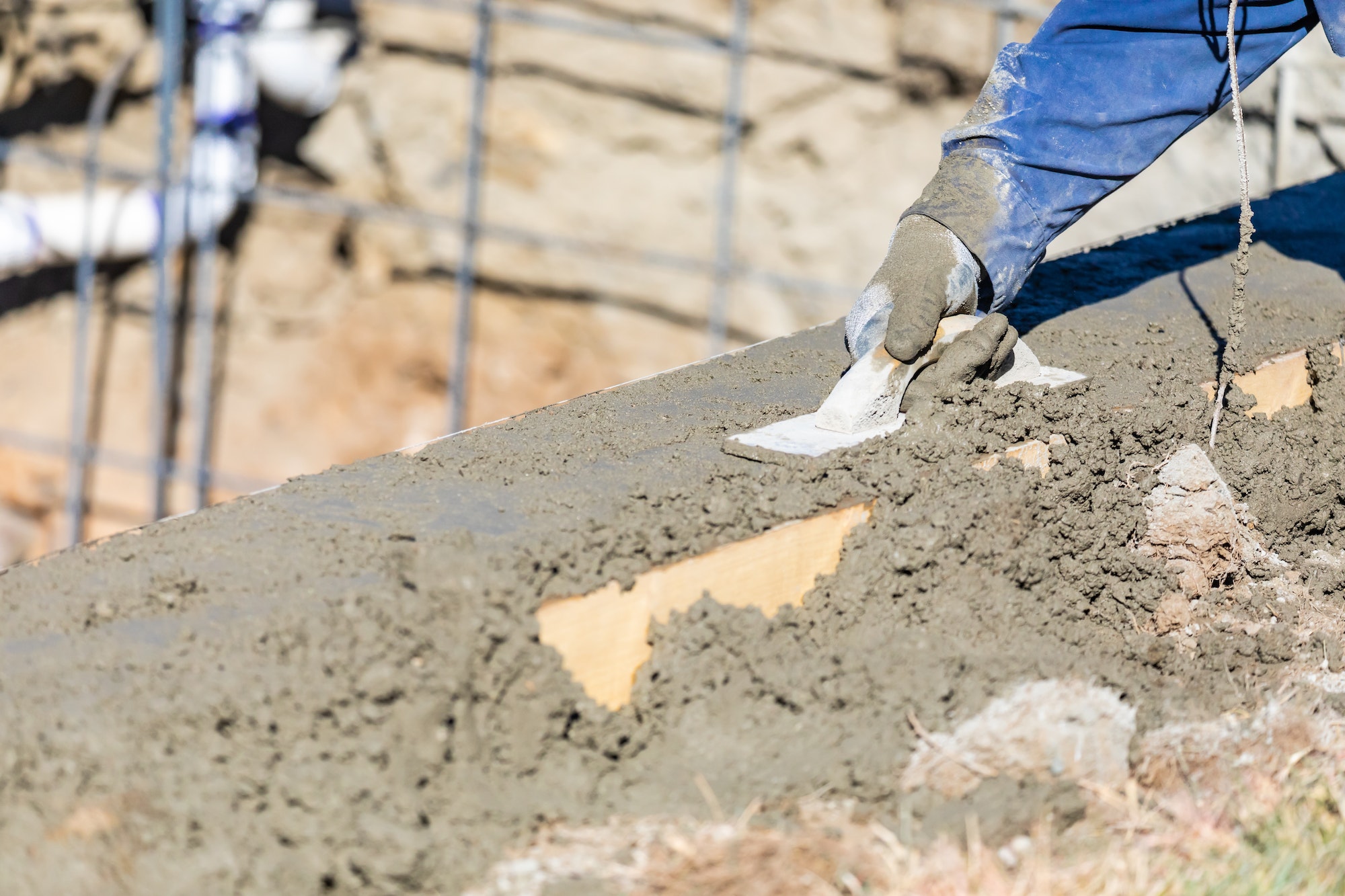 Pool Construction Worker Working With Wood Float On Wet Concrete